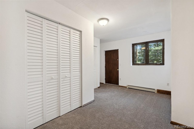 4835 Abo Ln, Monument, CO 80132 - unfurnished bedroom featuring a baseboard heating unit, carpet flooring, a closet, and baseboards