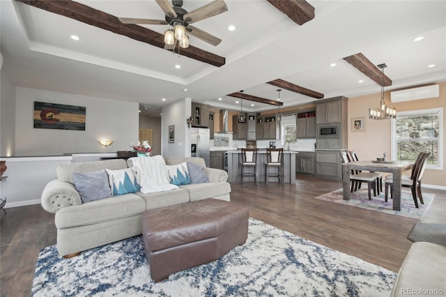 living room with sink, ceiling fan with notable chandelier, and dark hardwood / wood-style flooring