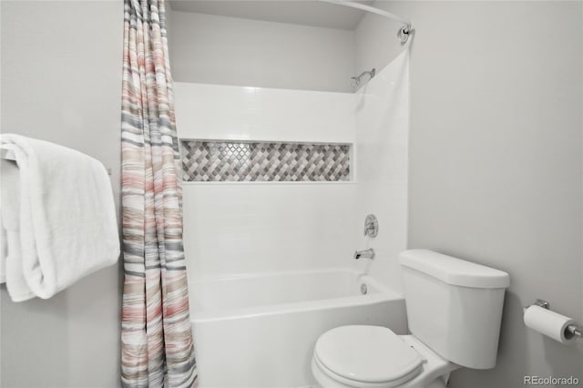 bathroom with toilet and shower / bath combo with shower curtain