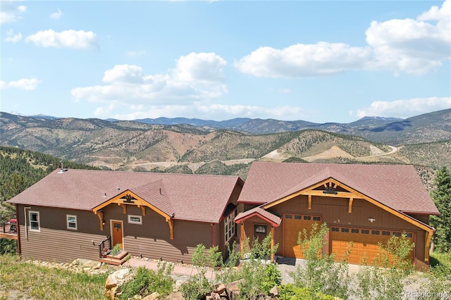 ranch-style house with a garage and a mountain view