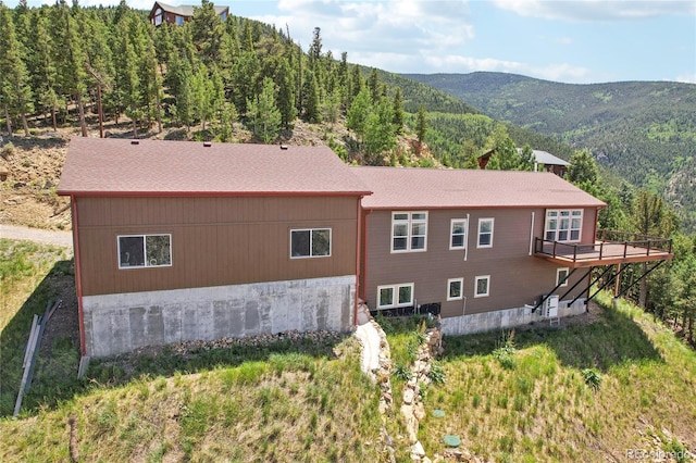 back of house featuring a deck with mountain view