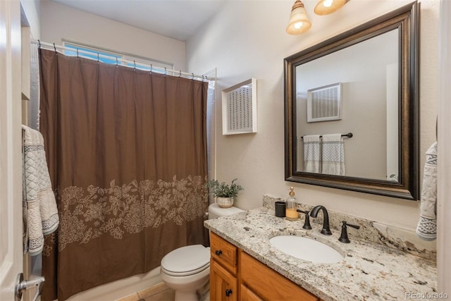 bathroom featuring vanity, tile patterned flooring, and toilet