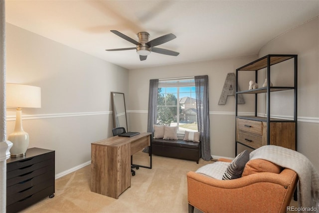 carpeted office space featuring ceiling fan