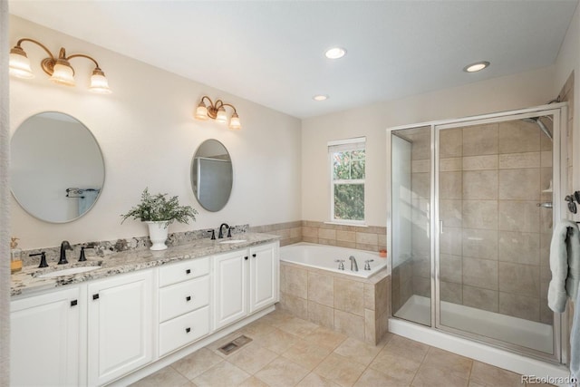 bathroom featuring shower with separate bathtub, vanity, and tile patterned floors