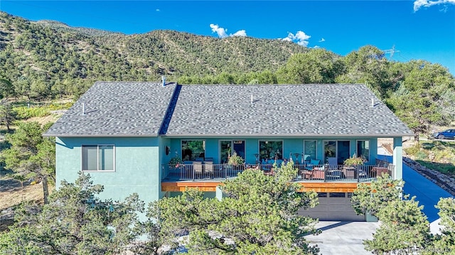 view of front of property with a mountain view, a porch, and a garage