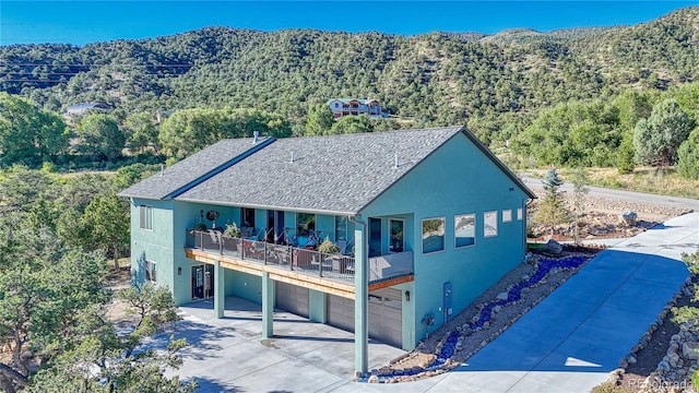 exterior space with a mountain view, a garage, and a balcony