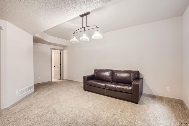 living room with a textured ceiling and carpet floors