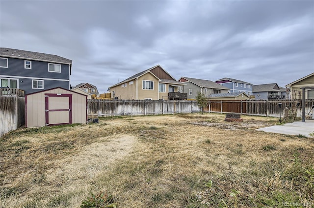 view of yard featuring a water view and a storage shed