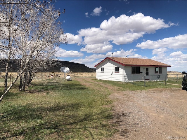 view of side of property featuring fence