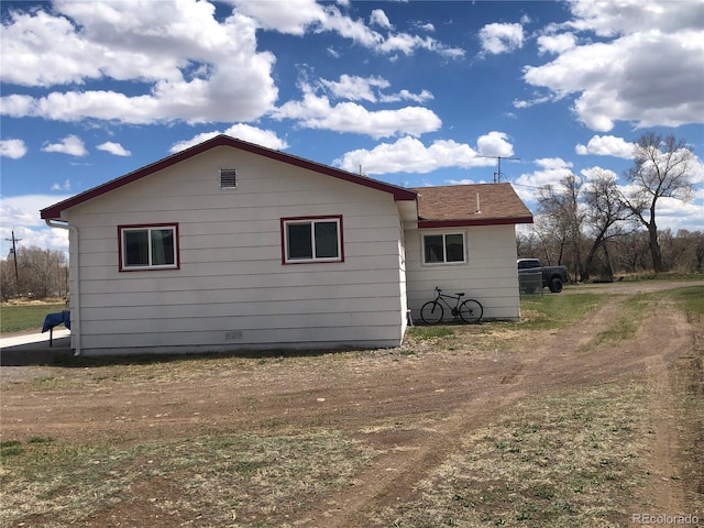 view of property exterior featuring a shingled roof