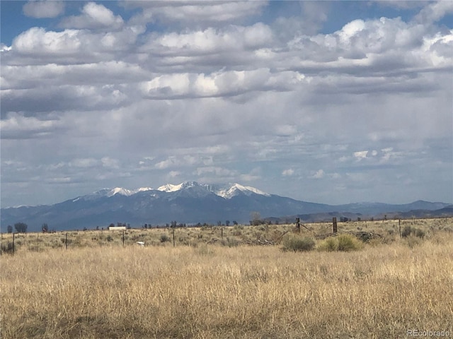 view of mountain backdrop with rural landscape