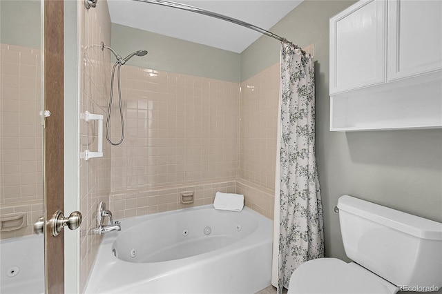 bathroom with toilet and a combined bath / shower with jetted tub
