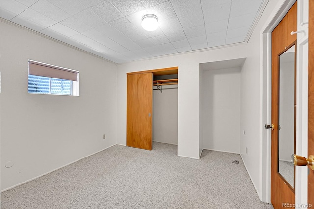 unfurnished bedroom featuring carpet floors and a closet