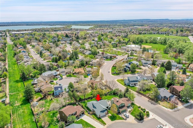 bird's eye view with a water view and a residential view
