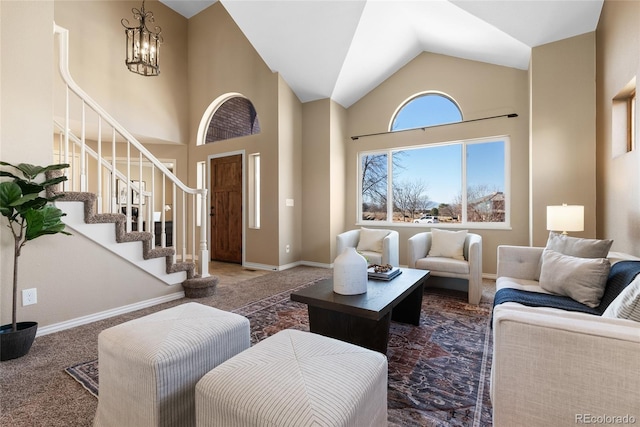 living room with high vaulted ceiling, a notable chandelier, and carpet flooring