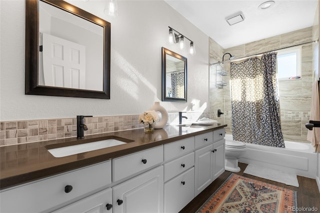 full bathroom featuring tasteful backsplash, vanity, toilet, and shower / bath combo with shower curtain