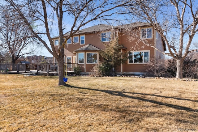 view of front of home featuring a deck and a front yard