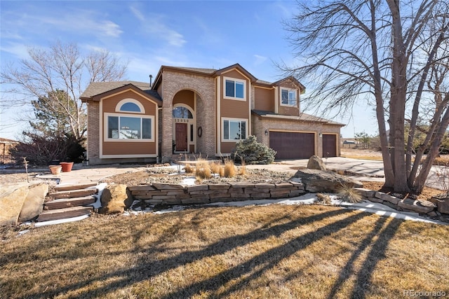 view of front facade with a garage and a front lawn