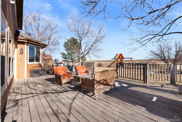 wooden deck featuring a playground and outdoor lounge area