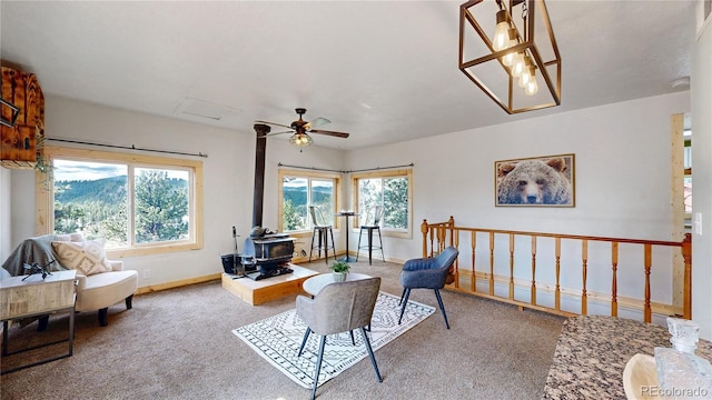 60 Ball Rd, Bailey, CO 80421 - living room featuring a wood stove, carpet flooring, and healthy amount of natural light