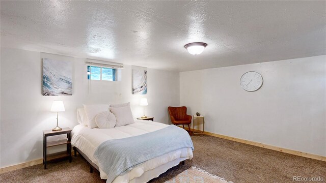 60 Ball Rd, Bailey, CO 80421 - bedroom featuring a textured ceiling, carpet floors, and baseboards