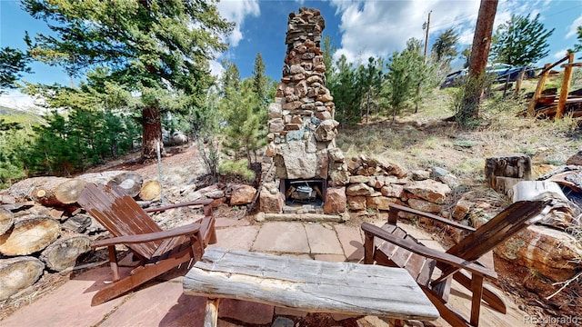 60 Ball Rd, Bailey, CO 80421 - view of patio with an outdoor stone fireplace