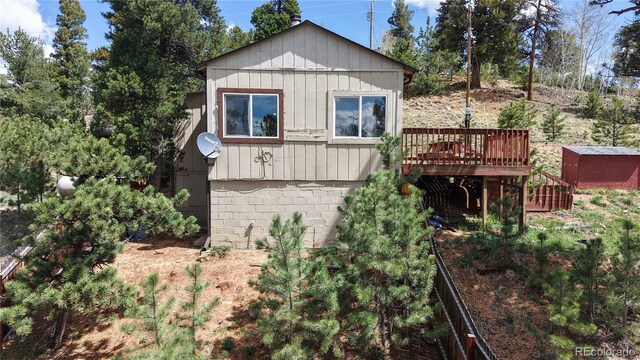 60 Ball Rd, Bailey, CO 80421 - view of home's exterior featuring a wooden deck, board and batten siding, and stairs