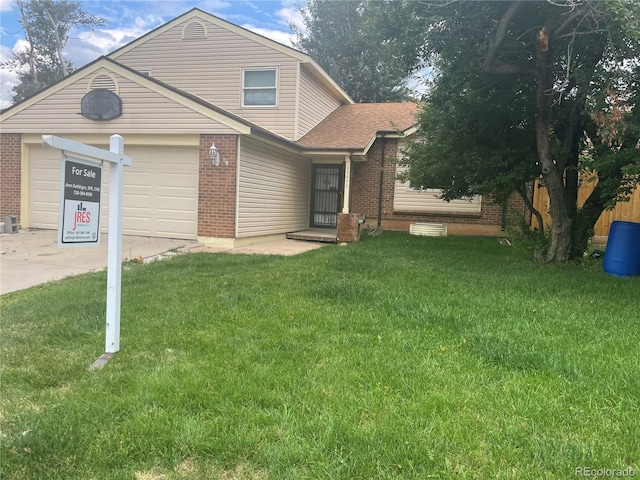 view of front of house featuring a front lawn and a garage