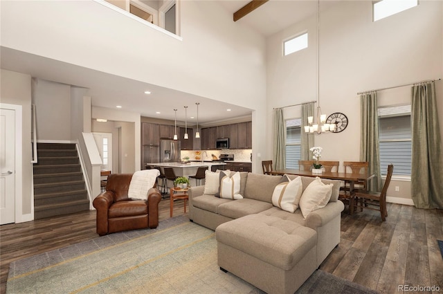 living room with baseboards, a high ceiling, stairs, and dark wood-style flooring
