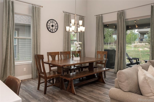 dining space with a chandelier, wood finished floors, a wealth of natural light, and baseboards
