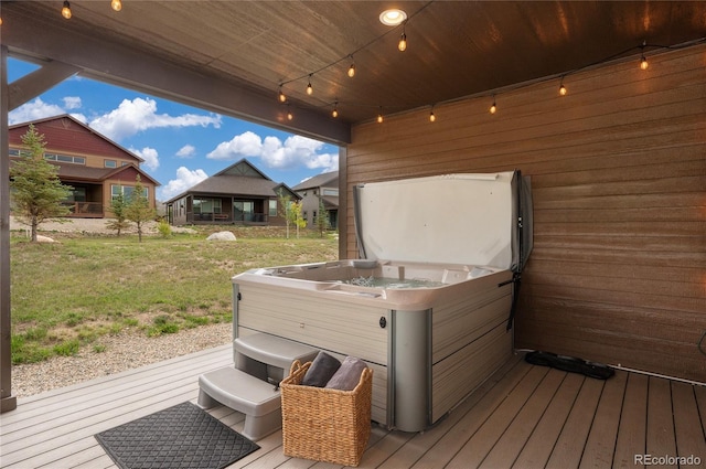 wooden deck featuring a yard and a hot tub