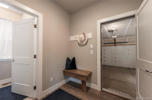 mudroom with baseboards, wood finished floors, and visible vents