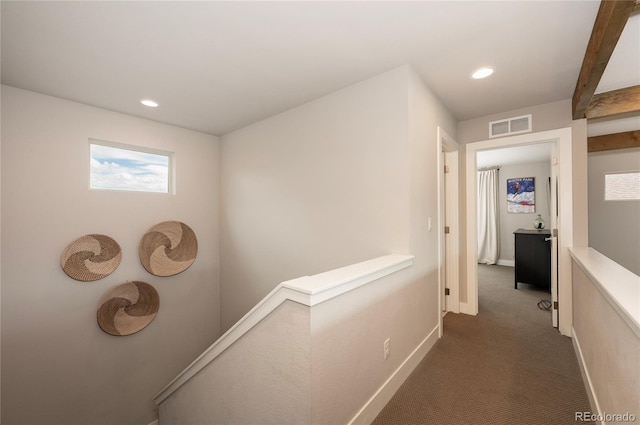 hall featuring an upstairs landing, baseboards, dark colored carpet, visible vents, and recessed lighting