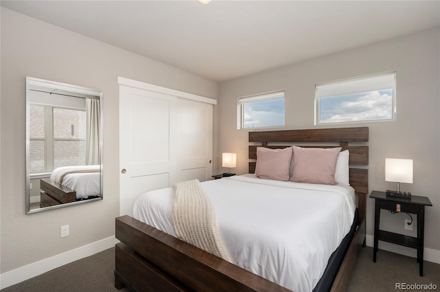 carpeted bedroom with baseboards, a closet, and multiple windows