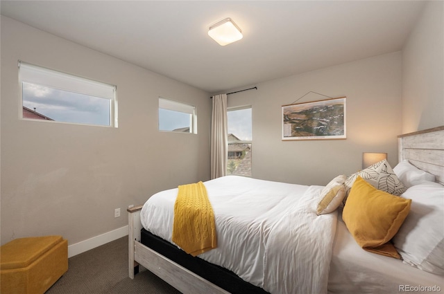 carpeted bedroom featuring baseboards