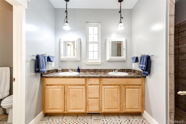 full bathroom featuring tile patterned flooring, a sink, toilet, and double vanity