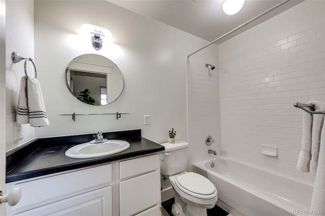 bathroom with washtub / shower combination, vanity, and toilet