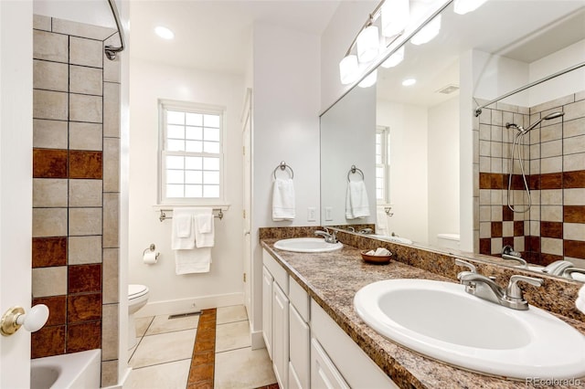 full bathroom featuring toilet, tile patterned flooring, baseboards, and a sink