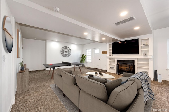 carpeted living room with built in features, a fireplace, recessed lighting, visible vents, and baseboards