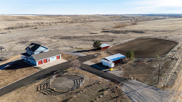 birds eye view of property with view of desert and a rural view