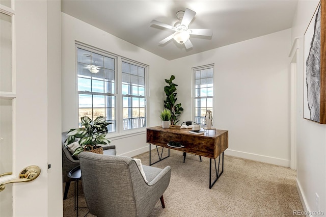 home office featuring light carpet, ceiling fan, and baseboards