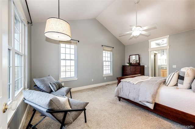 bedroom with carpet floors, baseboards, vaulted ceiling, and connected bathroom