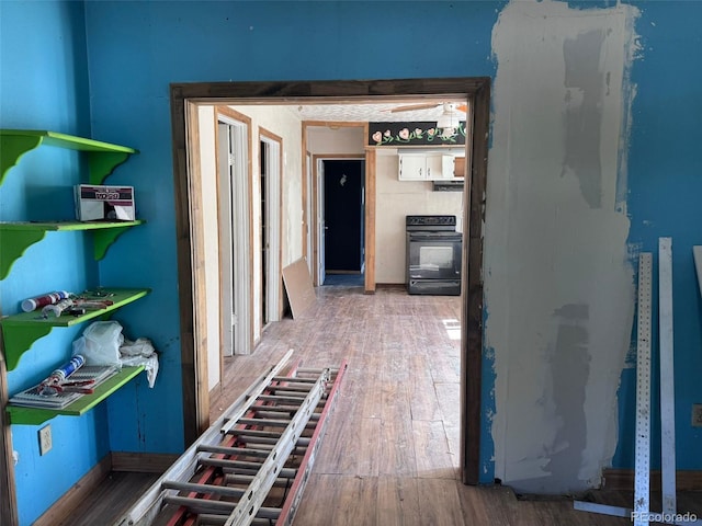 hall with wood finished floors and baseboards