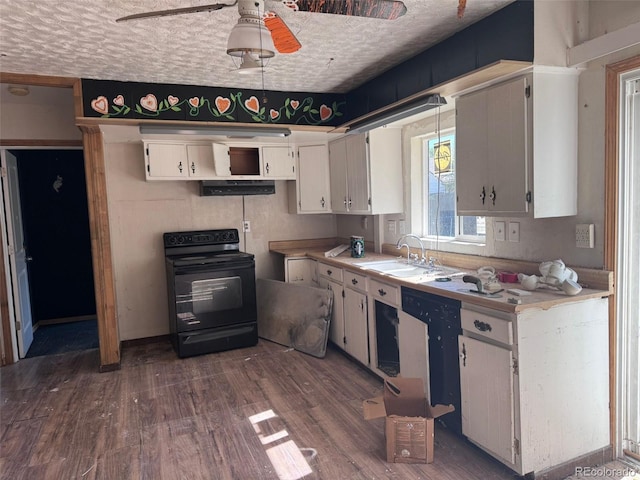 kitchen featuring light countertops, a textured ceiling, a ceiling fan, dark wood finished floors, and black range with electric stovetop