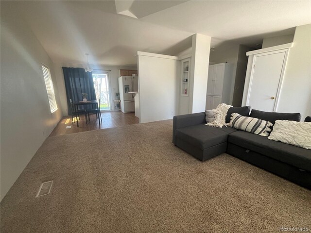 235 Marion St, Burlington, CO 80807 - carpeted living area featuring lofted ceiling and wood finished floors