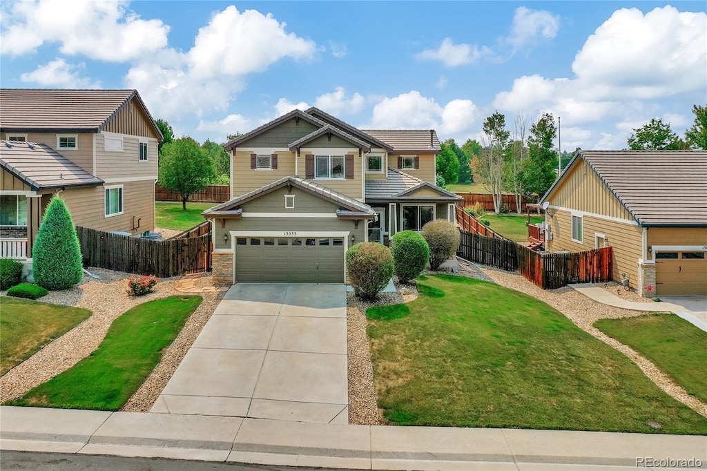 craftsman-style house with a garage and a front lawn