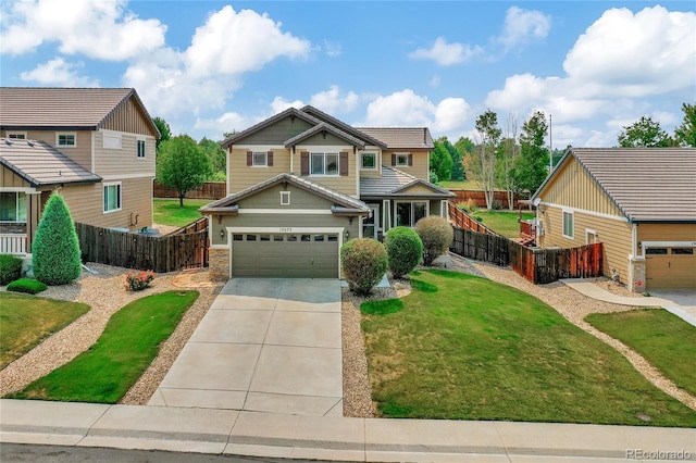 craftsman-style house with a garage and a front lawn