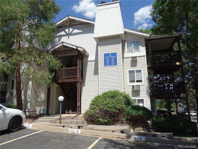 view of building exterior with uncovered parking