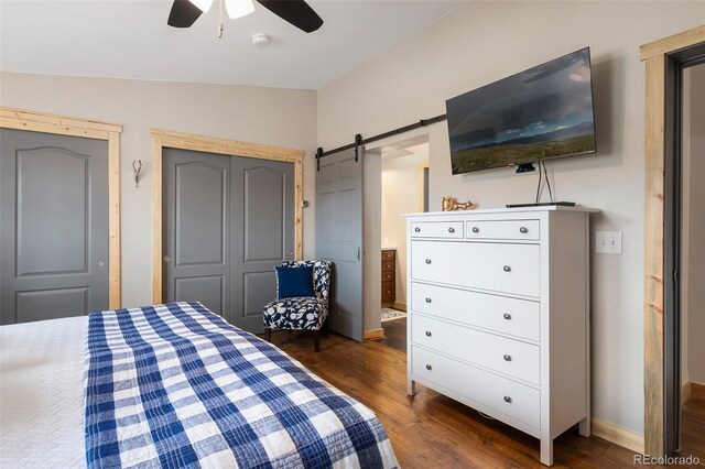 110 County Road 652, Grand Lake, CO 80447 - bedroom with vaulted ceiling, dark wood-style flooring, a barn door, baseboards, and ceiling fan
