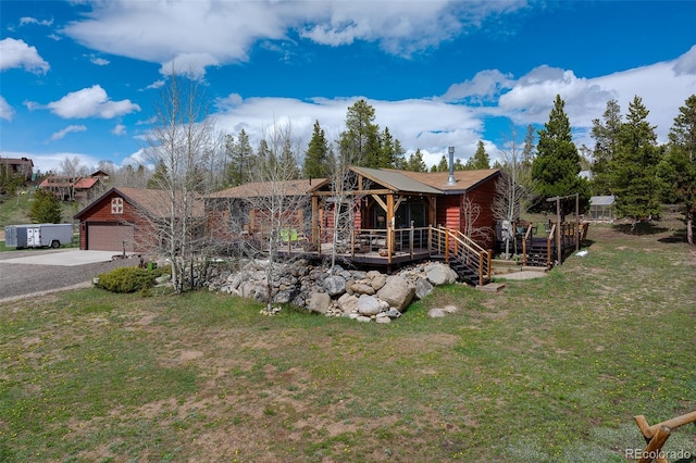 110 County Road 652, Grand Lake, CO 80447 - view of front of home with a deck, a front yard, and gravel driveway